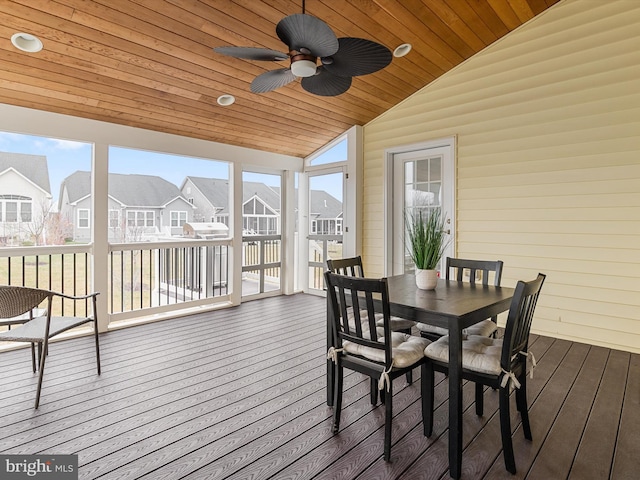 sunroom / solarium with a residential view, wood ceiling, a healthy amount of sunlight, and vaulted ceiling