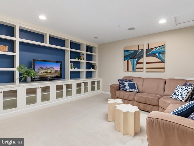 living room with carpet flooring, recessed lighting, built in shelves, and attic access