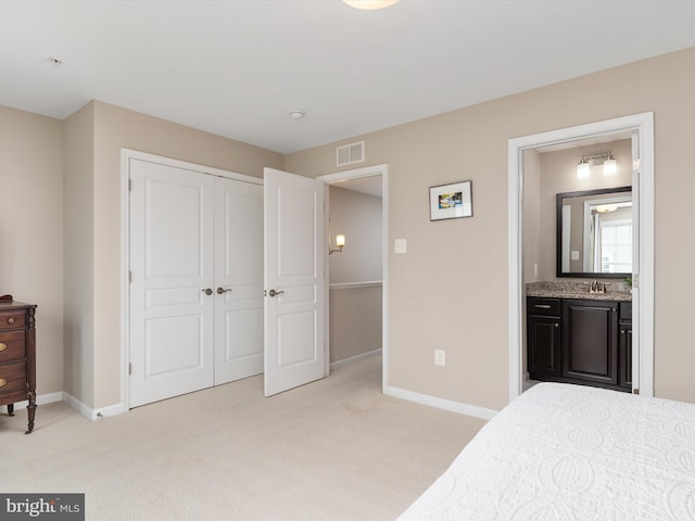 bedroom featuring light carpet, visible vents, connected bathroom, and baseboards