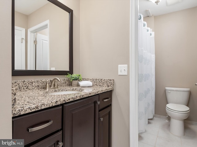 full bath with vanity, tile patterned floors, toilet, and baseboards