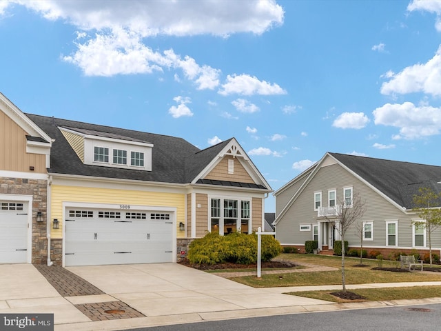 view of front of home featuring stone siding, concrete driveway, a garage, and roof with shingles