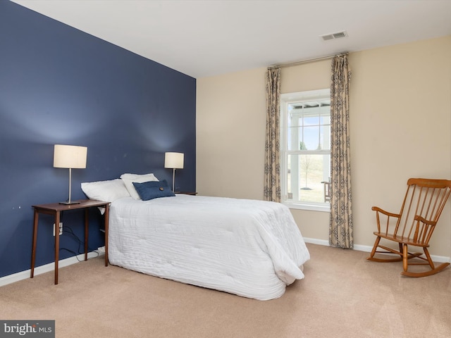 bedroom featuring visible vents, baseboards, and carpet