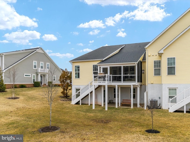 back of house with central air condition unit, a lawn, stairs, and a sunroom