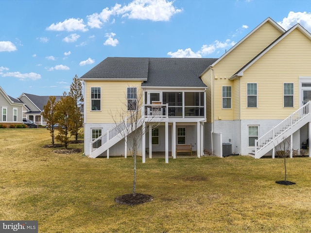 back of property with central AC unit, stairs, a yard, and a sunroom