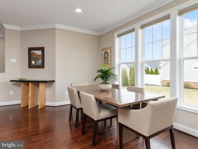 dining area featuring baseboards, dark wood-style floors, and crown molding