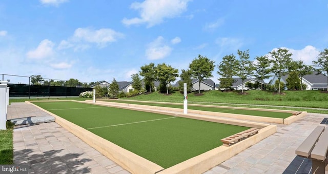 view of home's community featuring a lawn and fence