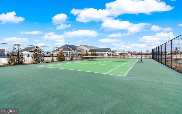 view of sport court featuring fence