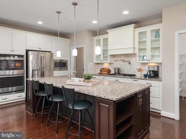 kitchen with tasteful backsplash, dark wood-style floors, appliances with stainless steel finishes, and white cabinetry