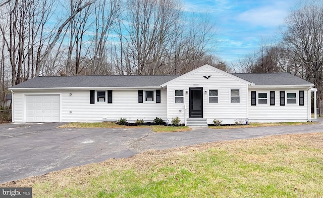 ranch-style home with a front lawn and a garage