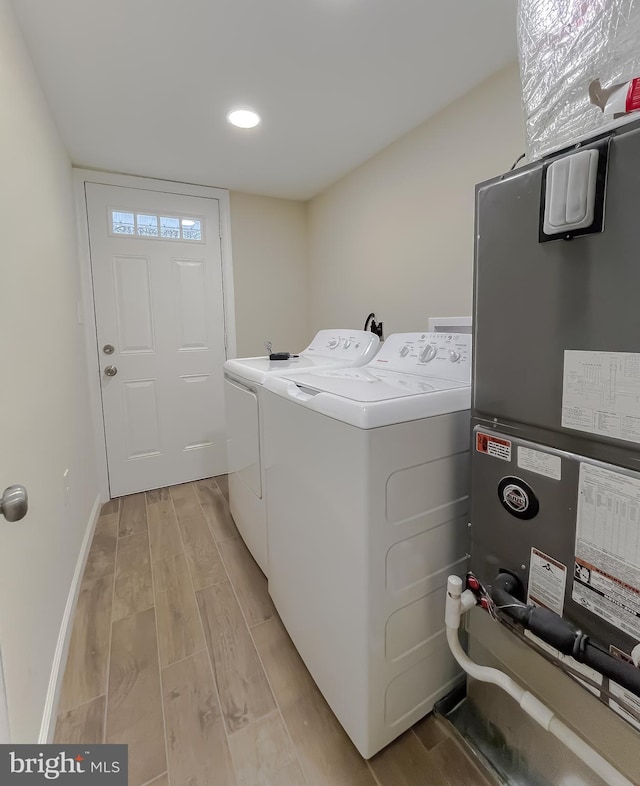 laundry area with washing machine and dryer and heating unit