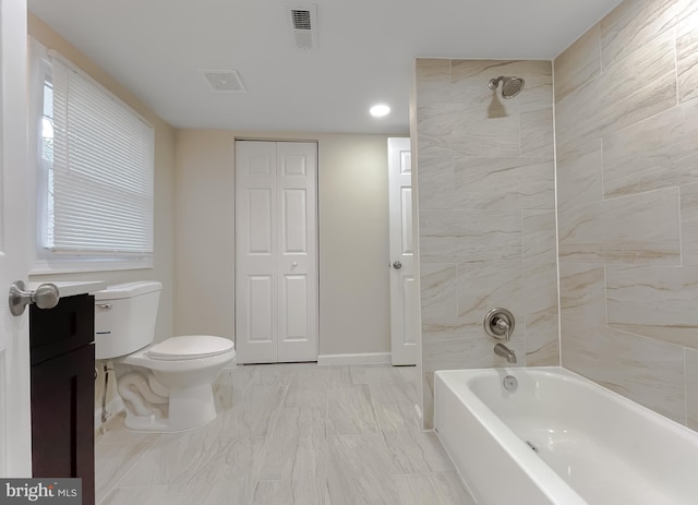 full bathroom with vanity, tiled shower / bath combo, and toilet