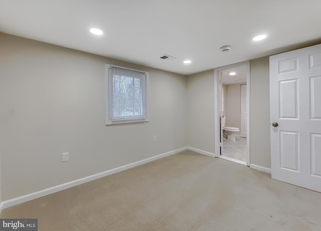 unfurnished bedroom featuring carpet flooring and ensuite bath