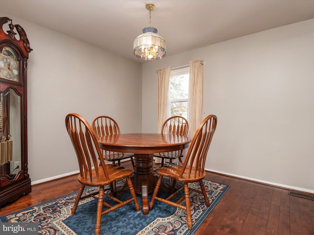 dining room featuring an inviting chandelier and dark hardwood / wood-style floors