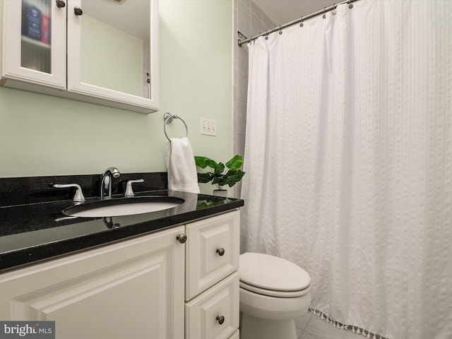 bathroom featuring tile patterned flooring, vanity, and toilet