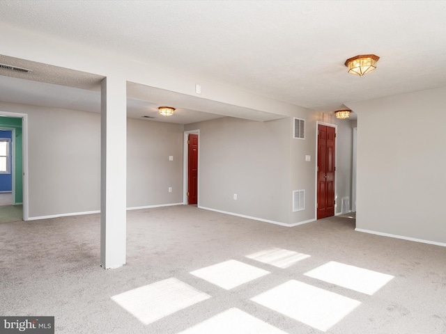 unfurnished room with carpet floors and a textured ceiling