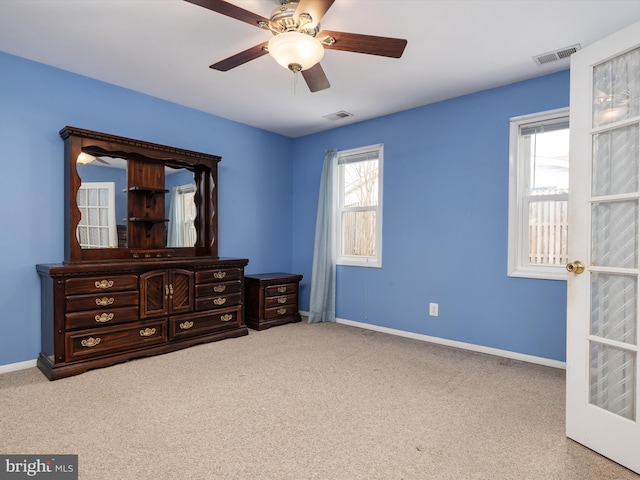 bedroom featuring light carpet, french doors, and ceiling fan