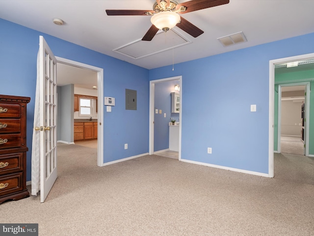 unfurnished bedroom with light carpet, electric panel, and ceiling fan