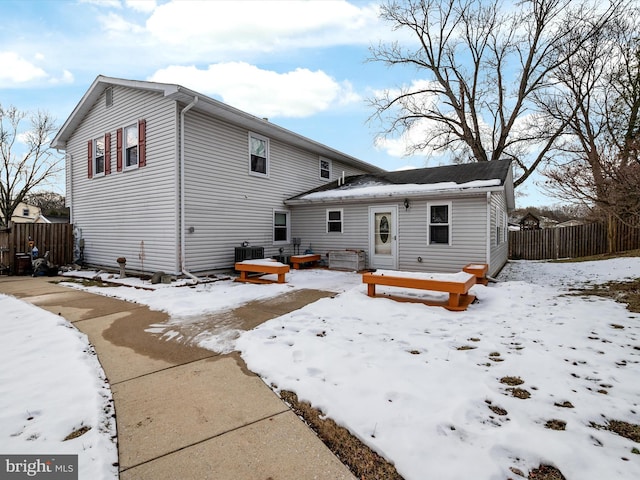 snow covered property featuring central AC unit