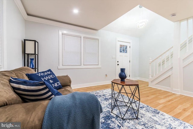 living room featuring wood-type flooring and ornamental molding