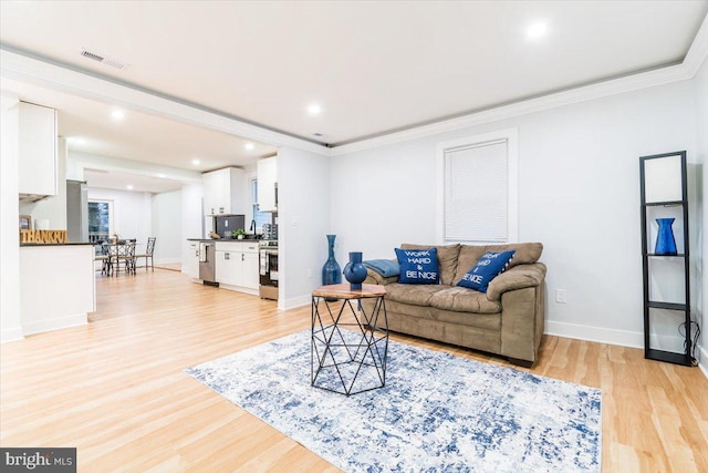 living room featuring light hardwood / wood-style floors and ornamental molding