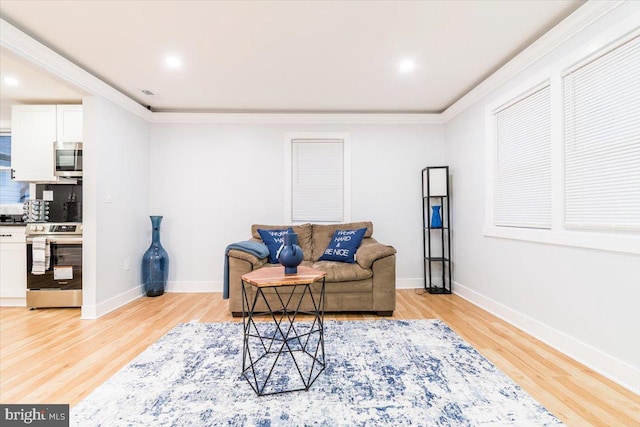 living room with light hardwood / wood-style floors and crown molding