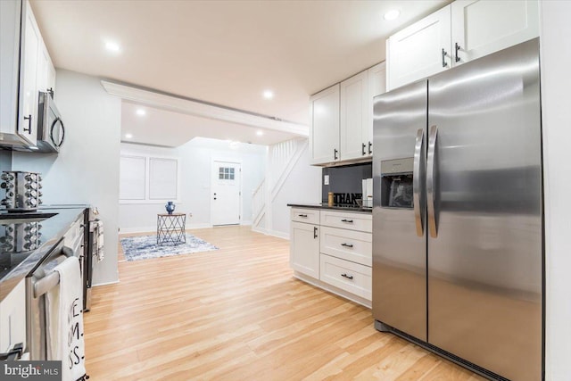 kitchen featuring white cabinets, light wood-type flooring, and appliances with stainless steel finishes