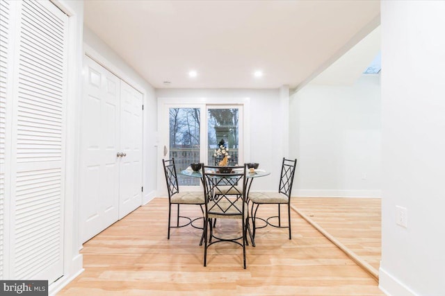 dining space with light hardwood / wood-style floors