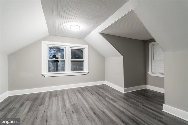 bonus room with lofted ceiling and dark wood-type flooring