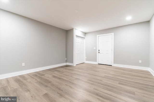 spare room with light hardwood / wood-style flooring