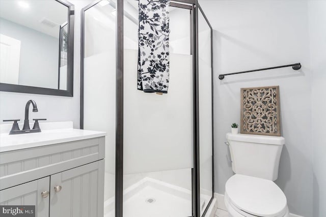 bathroom with a shower with door, vanity, and toilet