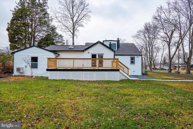 rear view of property featuring a wooden deck and a yard