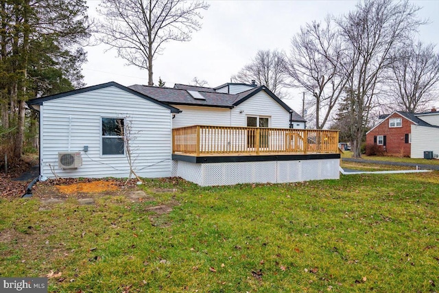 rear view of property with a yard, ac unit, and a deck