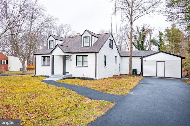 cape cod-style house with central AC unit and a front lawn