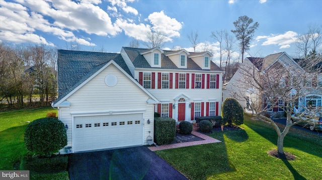 view of front of house with a garage and a front yard