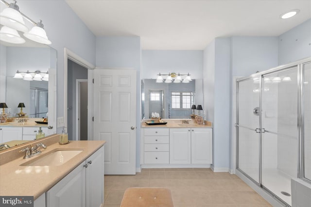 bathroom with tile patterned floors, vanity, and walk in shower