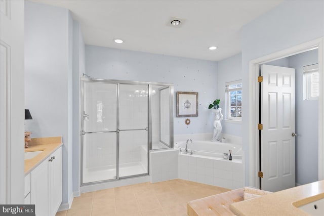 bathroom featuring tile patterned floors, vanity, separate shower and tub, and a wealth of natural light