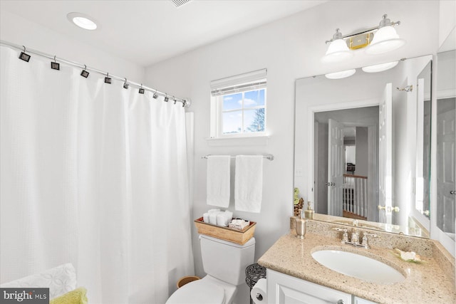 bathroom with vanity and toilet