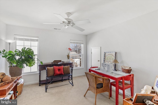 carpeted home office featuring ceiling fan and plenty of natural light