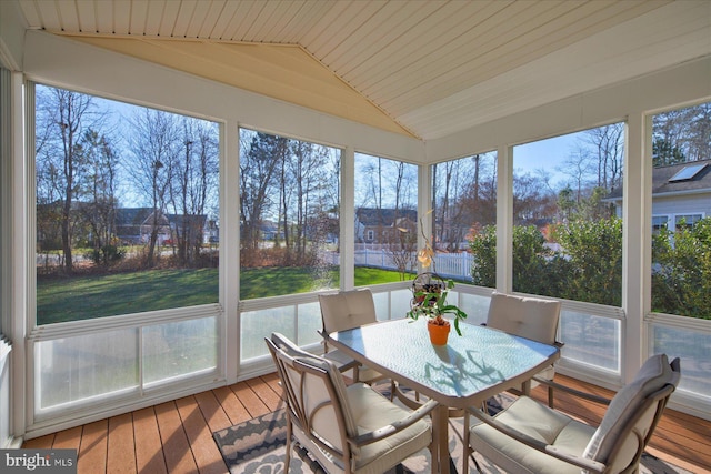 sunroom featuring a healthy amount of sunlight, lofted ceiling, and wood ceiling