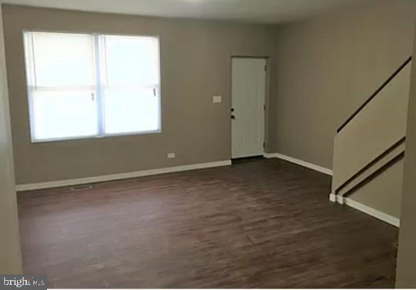 interior space with dark hardwood / wood-style floors