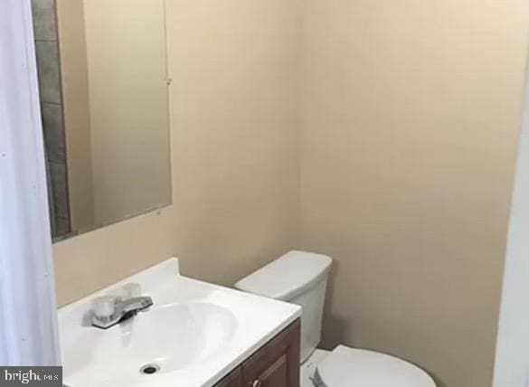 bathroom featuring vanity and toilet