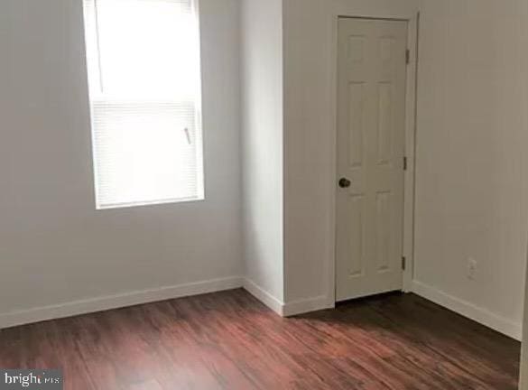 spare room featuring dark hardwood / wood-style floors