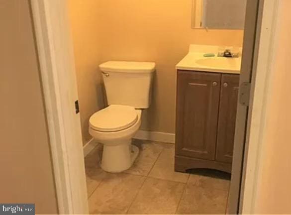 bathroom with tile patterned floors, vanity, and toilet