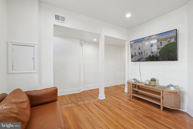 sitting room featuring baseboards, wood finished floors, visible vents, and recessed lighting