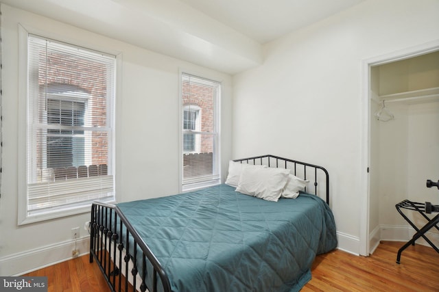 bedroom featuring baseboards and wood finished floors