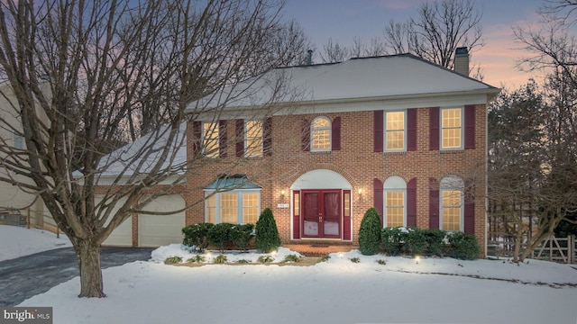 colonial home with a garage