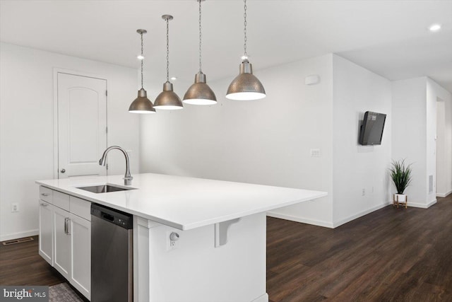 kitchen featuring sink, stainless steel dishwasher, pendant lighting, a center island with sink, and white cabinets