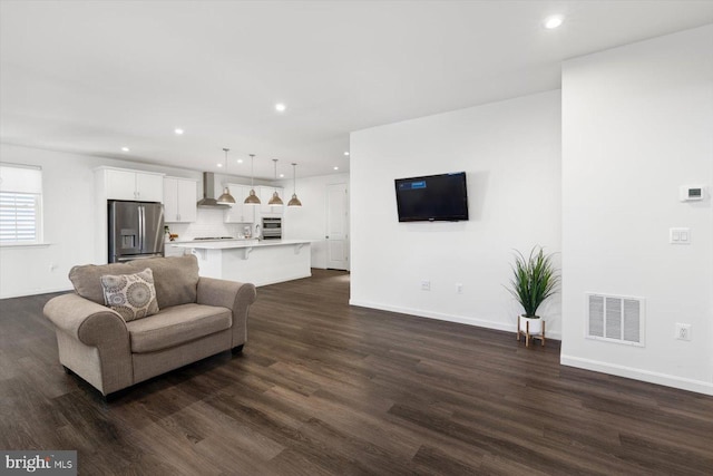 living room with dark hardwood / wood-style flooring