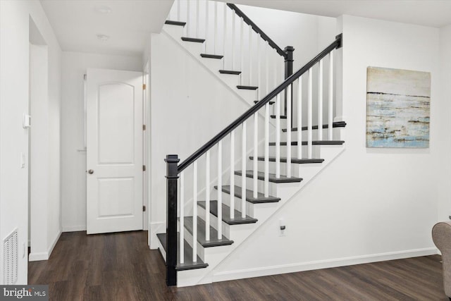 stairway featuring hardwood / wood-style floors