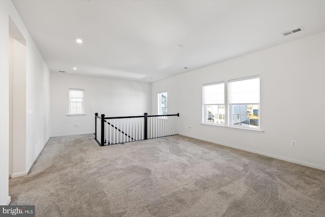 unfurnished room featuring light colored carpet